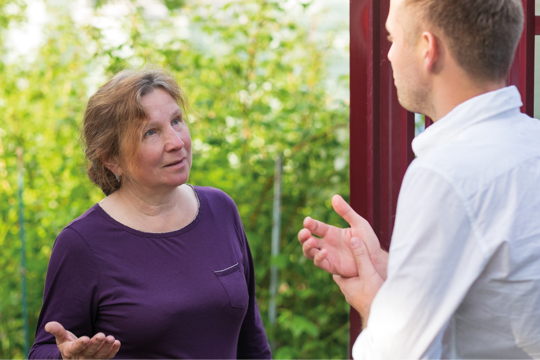 A man talking with a woman outside A man talking with a woman outside