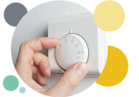 A persons hand adjusting the thermostat