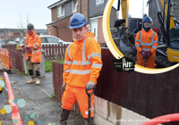 Three construction workers in orange Hi vis and blue hard hats