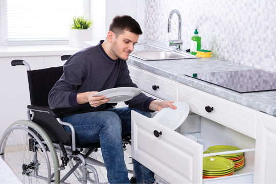 A man in a wheelchair filling his draw with his plates A man in a wheelchair filling his draw with his plates