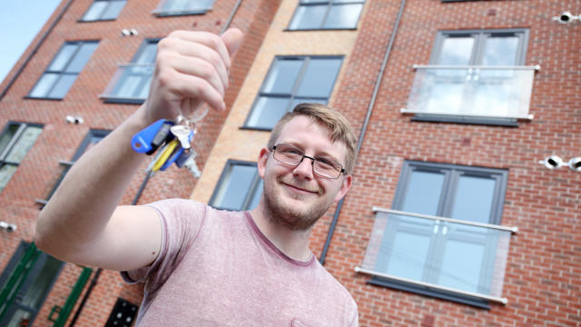 New home owner showing off his new keys