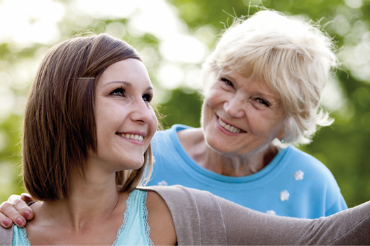 Two residents smiling and looking in the distance Two residents smiling and looking in the distance